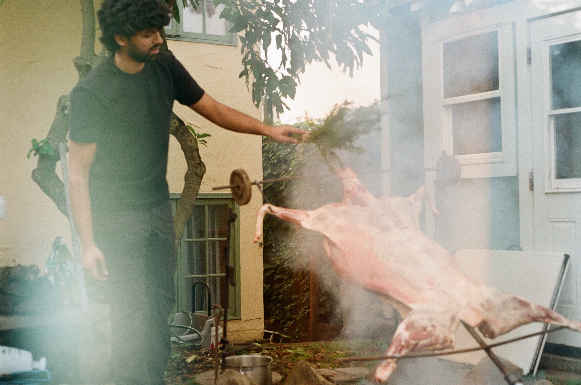 Akshay roasting a whole lamb over an open fire