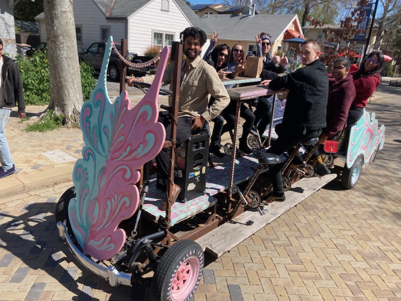 Akshay riding the Davis PartyBike with a full crew