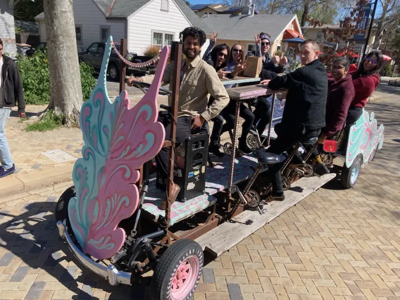 Akshay riding the Davis PartyBike with a full crew